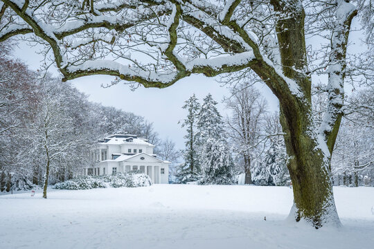 Winter landscape with snow and white villa in Go�lers Park Hamburg
