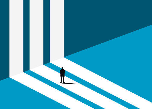 Solitary silhouette standing on a white path facing a blue wall