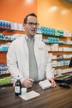 Pharmacist speaking during a consultation at the pharmacy counter