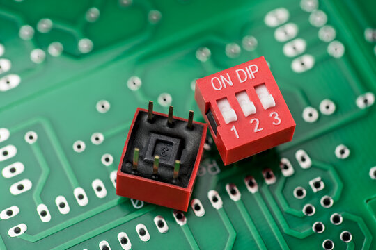 Dip switch components on a green printed circuit board.