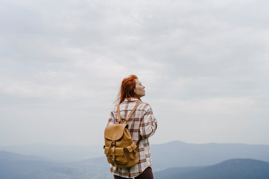 Tourist with backpack on mountain against morning sky in Sheregesh