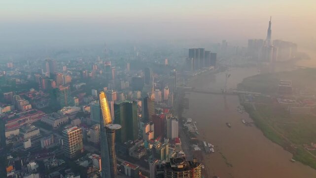 Aerial drone view of Ho Chi Minh City skyline with Saigon River, Ba Son Bridge, Landmark 81 and Bitexco Financial Tower