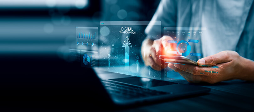Business professional using smartphone with digital dashboard interface labeled digital transformation, showing data charts, analytics panels, and network visualization for modern business technology