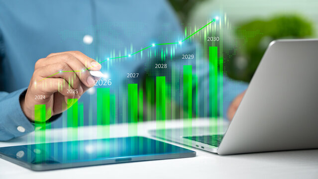 Businessman analysis green growth graph and sustainable investment strategy for year 2026 to 2030 with ESG goals and digital technology on virtual screen.