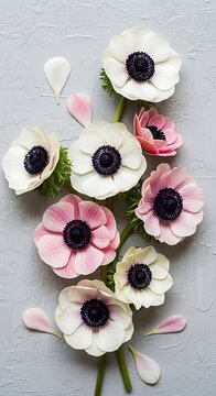 Assortment of pink and white springtime blossoms arranged vertically against a textured light background