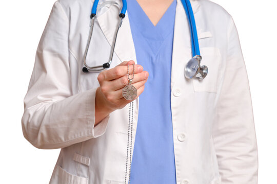 Woman doctor holding a bagua necklace pendant. Healthcare professional with stethoscope and taoist spiritual symbol. Concept of holistic medicine, balance and alternative healing approach.
