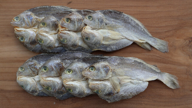 Salted Croaker Fish on Wooden Surface