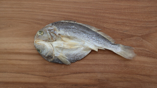 Top View of Salted Croaker Fish on Wooden Surface