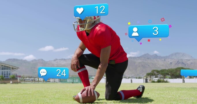 Kneeling football player wearing red jersey helmet holding ball on grass showing overlays 12 or 24 o