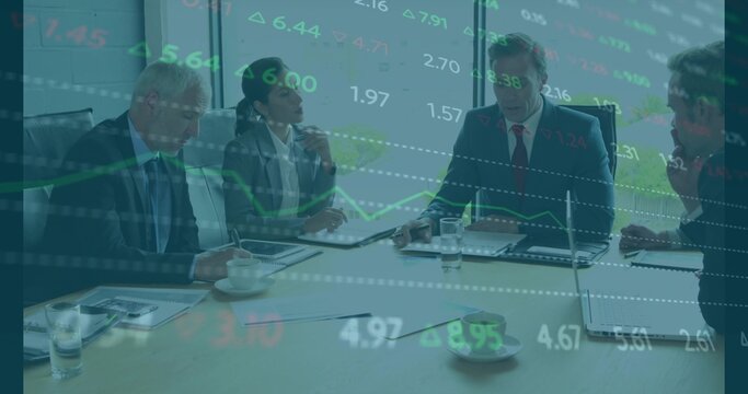 Discussing five business professionals reviewing market charts in boardroom, with laptops and suits