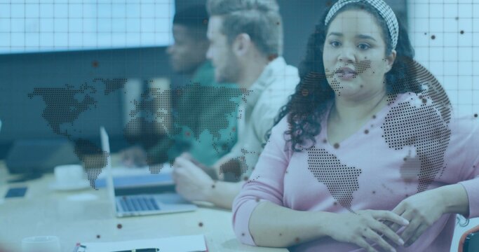 Leading woman pink sweater headband guiding meeting at conference table laptop world-map graphic