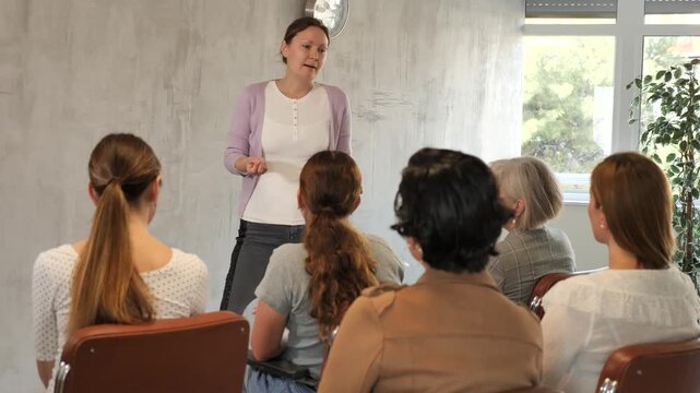  Adult woman lecturer speaks to audience 