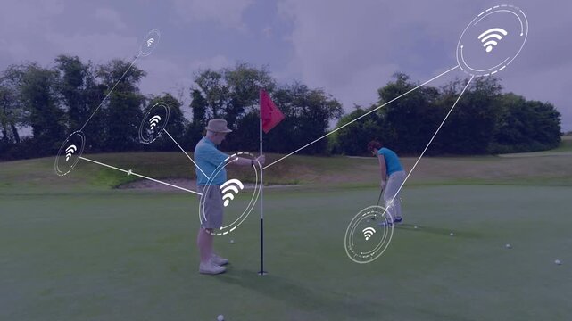 Senior man holding pin while senior woman lining up putt, golf nodes linking players and balls