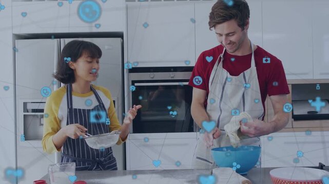 Woman sifting and speaking, man kneading dough on counter, blue icons floating, preparing bread