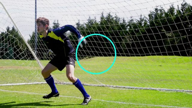 Male goalkeeper rising and tracking off-frame cue, leaping into goal net during sports training