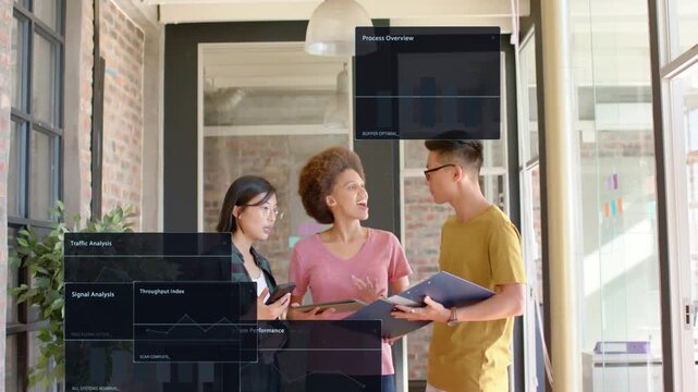 Team of three tapping devices and pointing tablet in office, tracking pipeline via tech panels %