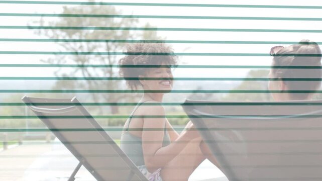 Curly woman sitting up poolside, leaning while chatting, striped overlay showing yellow cup leisure