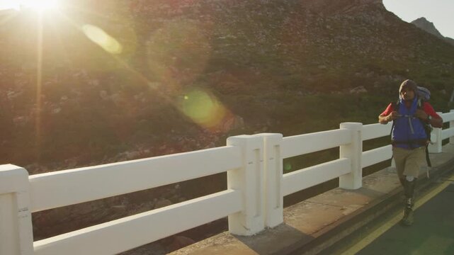 Outdoor hiker running bridge, beams sparking sweep on rail, passing near runner as prepping to trek