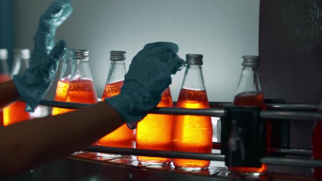 Beverage Bottling: A close-up view capturing the precise process of bottling beverages in a modern industrial setting. The image showcases the automated filling and sealing of glass bottles.