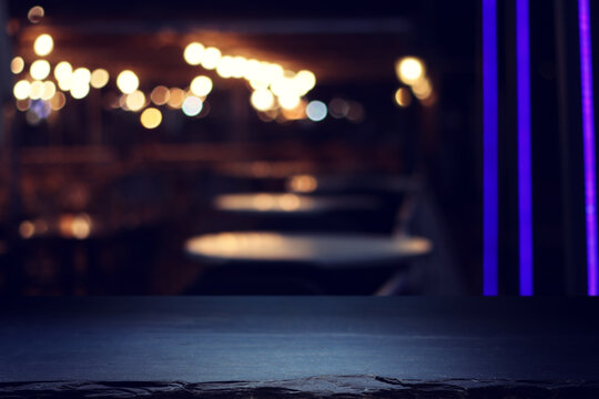 Black table and lights during night time. Product display or mockup