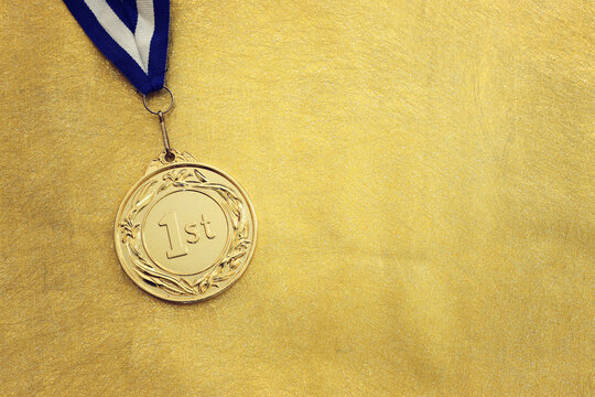 Golden medal on textured background
