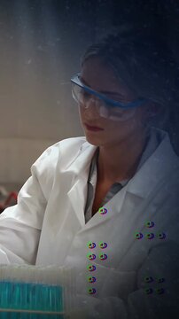 Vertical video: Lab tech reaching for turquoise tips selecting checking overlays drifting for QC