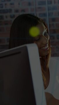 Vertical video: Office woman tapping keys, causing lime glare and green code overlay checking data