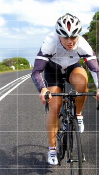 Vertical video: Woman cyclist pedaling coast bike tech causing grid lines over body showing metrics