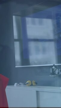 Vertical video: Camera panning left, showing gear and figure, blue overlay over figure for safety