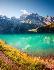 The most gorgeous Swiss lake Oeschinensee surrounded by grand mountains. Location Bernese Oberland, Switzerland, Europe. Photo wallpaper. © Leonid Tit