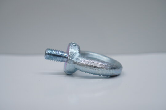 a close up of a metal nut on a white surface