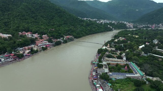 Aerial shot of Ram Jhula suspension bridge over Ganges River in Rishikesh India