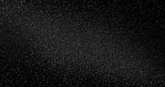 Abstract black texture. The slow, smooth diagonal movement of a dark, rough surface moving in a soft beam of light.
