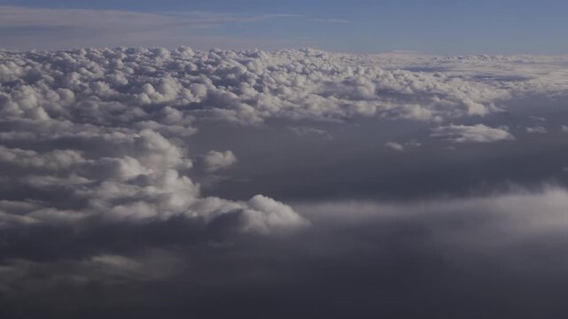 Clouds seen from inside a airplane window at 10km of height.