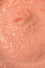 Fototapeta premium A detailed macro shot captures the creamy texture of pink fish roe spread with salmon showing small visible eggs in a close up view