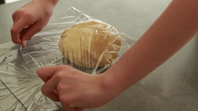 Close-up of a child's hands mixing butter cake batter in a bowl
