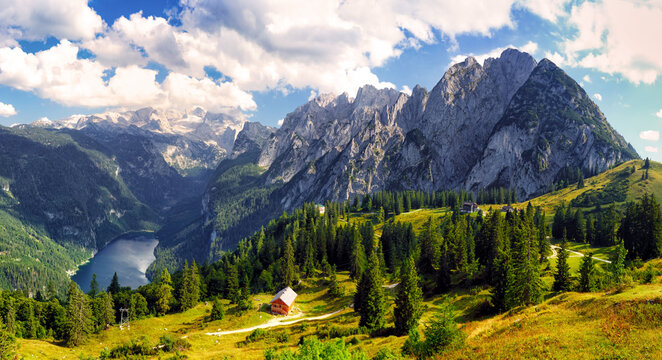 Beautiful view of idyllic colorful autumn scenery with Dachstein mountain summit reflecting in crystal clear Gosausee mountain lake.