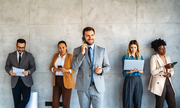 Multicultural professional businesspeople working together on research plan in boardroom.