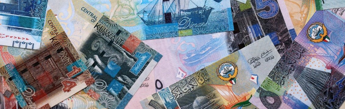 Kuwaiti dinar money bills pile on table. Kuwait banknotes of KWD currency close up.