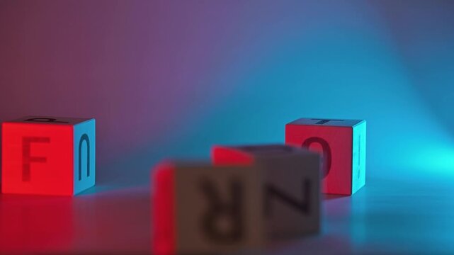 Colorful letter blocks are arranged on a surface to form a playful word against a colorful light backdrop