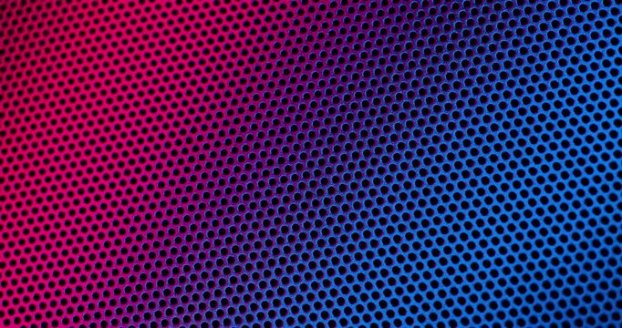 Color Perforated surface texture.  Close-up view of a color perforated surface with a repeating hole pattern, creating a textured and industrial look.