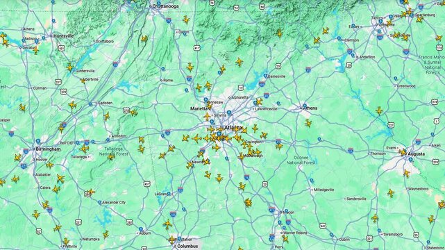 Air traffic map with multiple aircraft icons over Atlanta city region, real time aviation tracking interface showing routes and positions