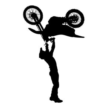 Silhouette of Freestyle Motocross Rider Performing Handstand Stunt in Mid-Air