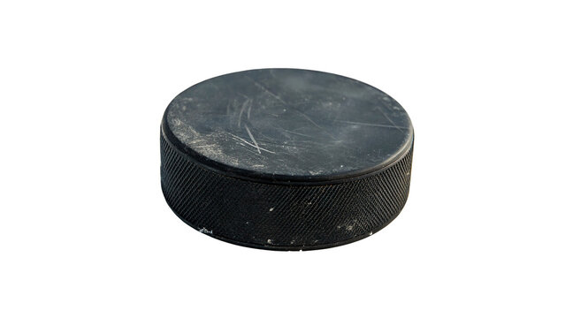 Hockey puck resting on a flat surface after practice session in ice rink at indoor facility isolated on transparent background