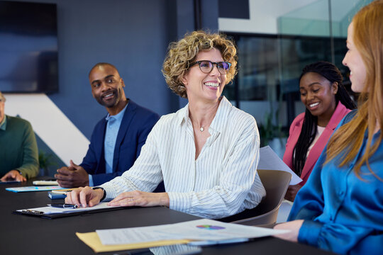 Mature businesswoman smiling during brainstorming