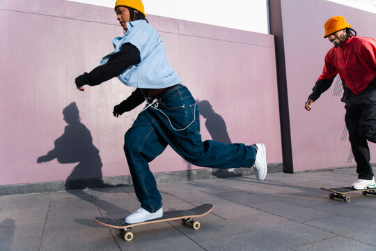 Friends skateboarding on the street in El Raval Barcelona