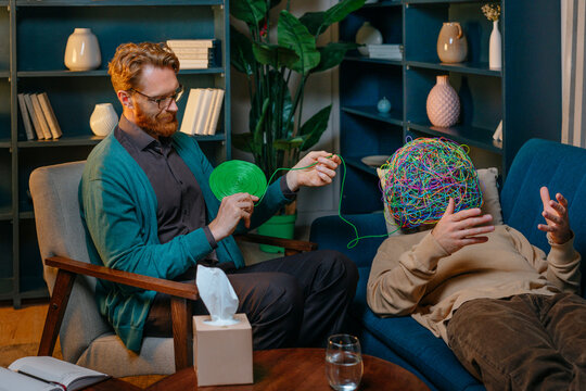 Psychotherapist assisting patient lying down on sofa