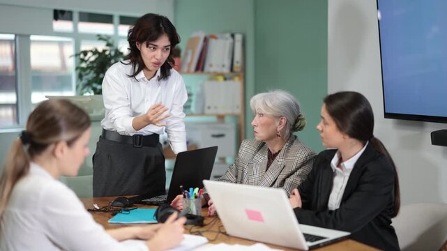 Standing Asian girl scold to round table gathering female staff at office. Management committee, meeting of working business group, board of business representatives