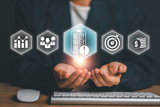 Hands presenting digital icons representing business strategy, success, and financial growth in a modern office setting.