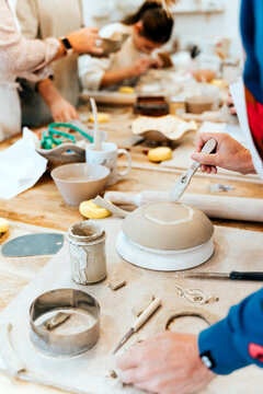 Artisans creating handmade ceramics and pottery in a creative workshop